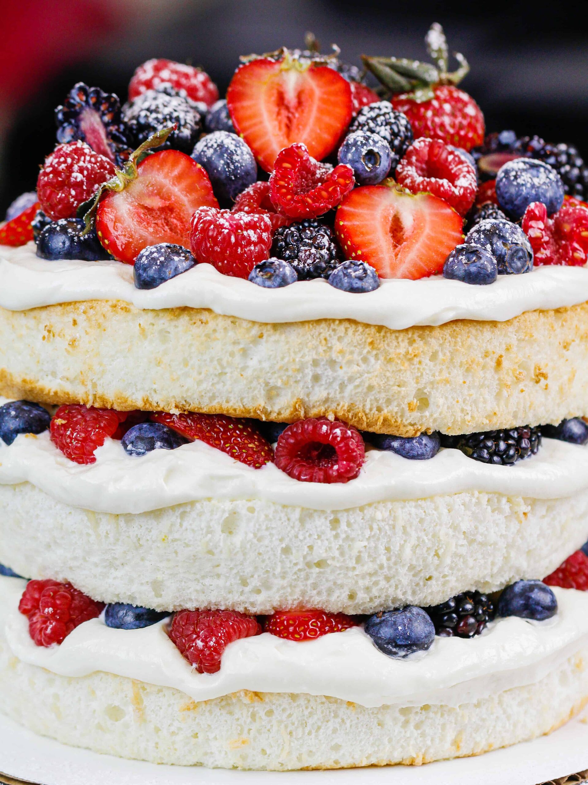 image of an angel food layer cake filled with loads of fresh berries and stabilized whipped cream

