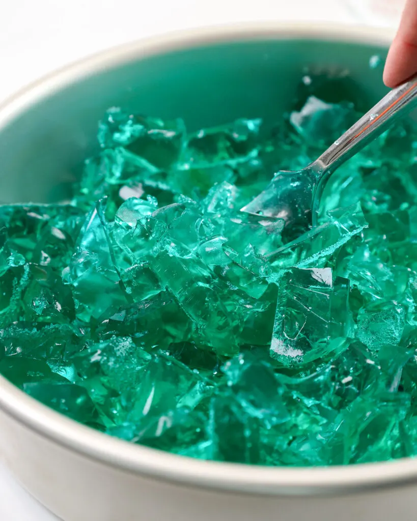 image of turquoise gelatin that's being crumbled to make a pretty gradient in a jelly ocean