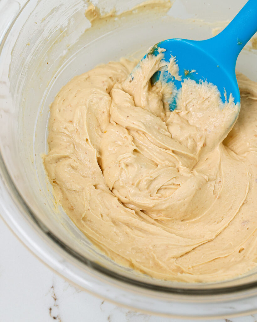 image of peanut butter cream cheese frosting that's been mixed and is ready to be used to fill macarons