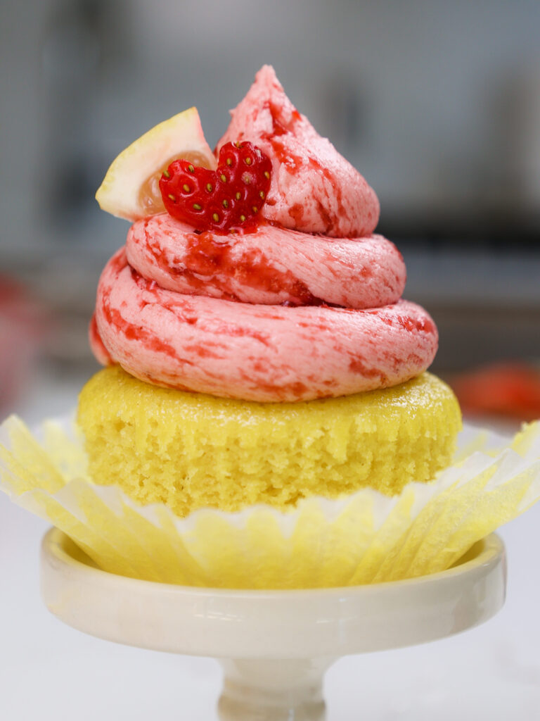 image of strawberry lemonade cupcakes decorated with a little lemon slice and cute heart shaped strawberry slice