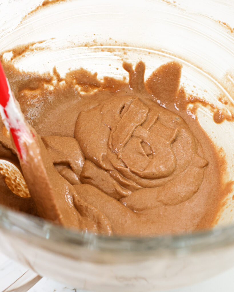 image of chocolate macaron batter that's been mixed the perfect amount to pass the figure 8 test