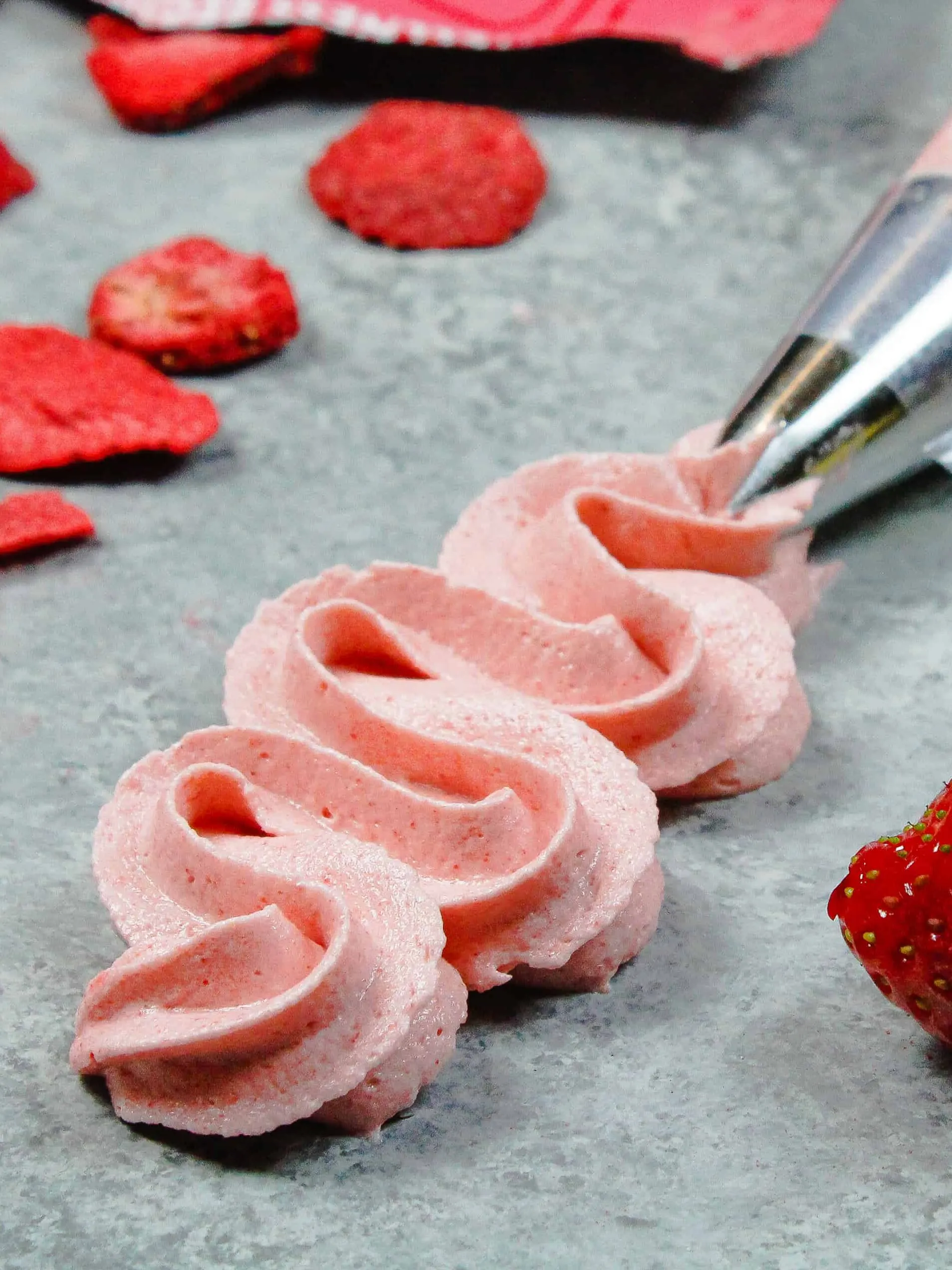 image of strawberry icing piped with a frosting tip