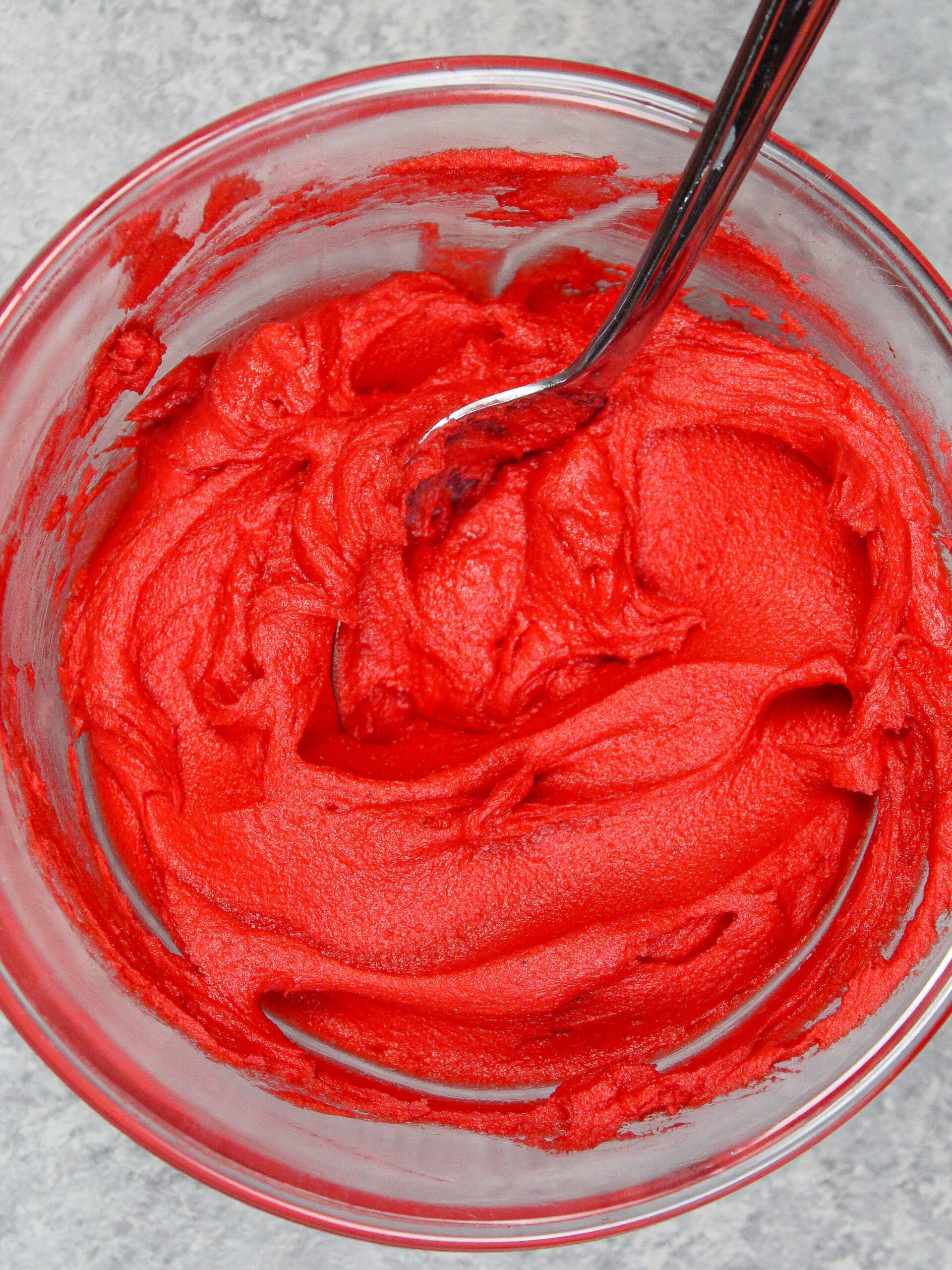 image of super bright red buttercream made using red gel food coloring and time to make sure it doesn't taste bitter or dye your mouth