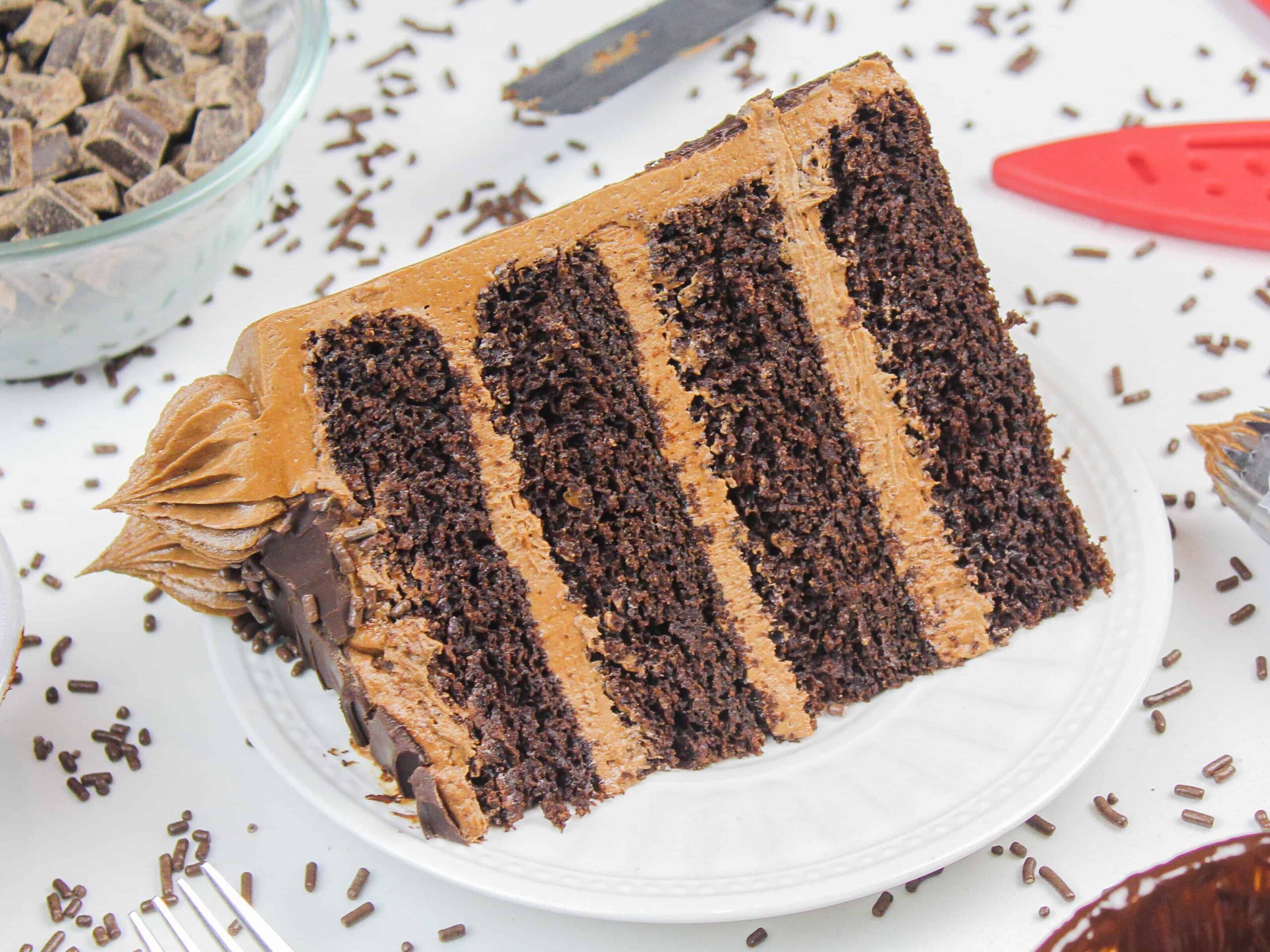 image of a slice of a moist and delicious gluten free chocolate cake with chocolate buttercream