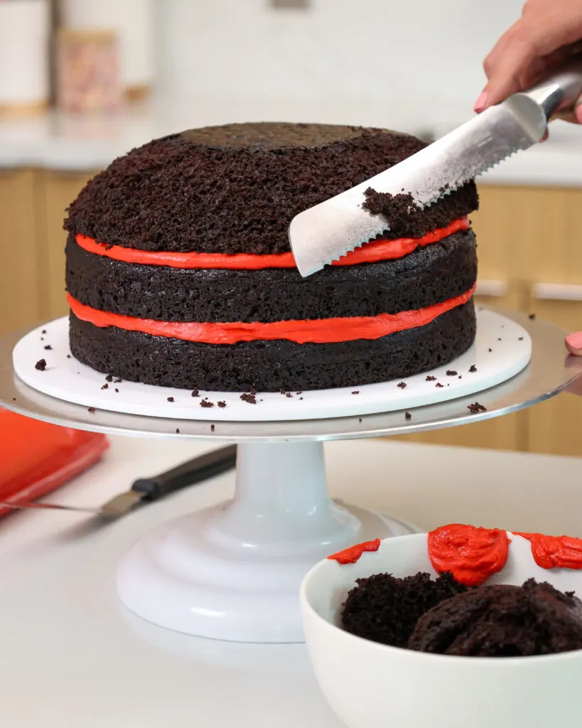 image of cake layers being trimmed with a serrated knife