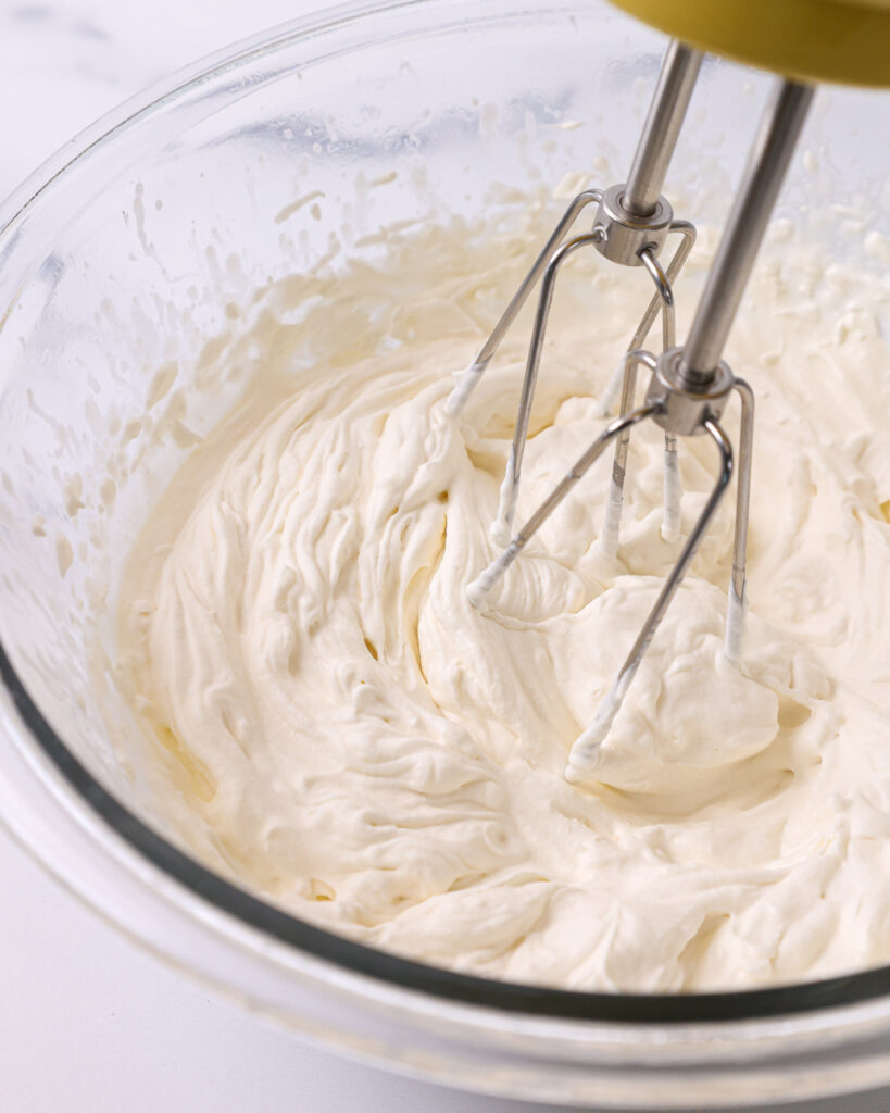 image of whipped cream being made with a hand mixer