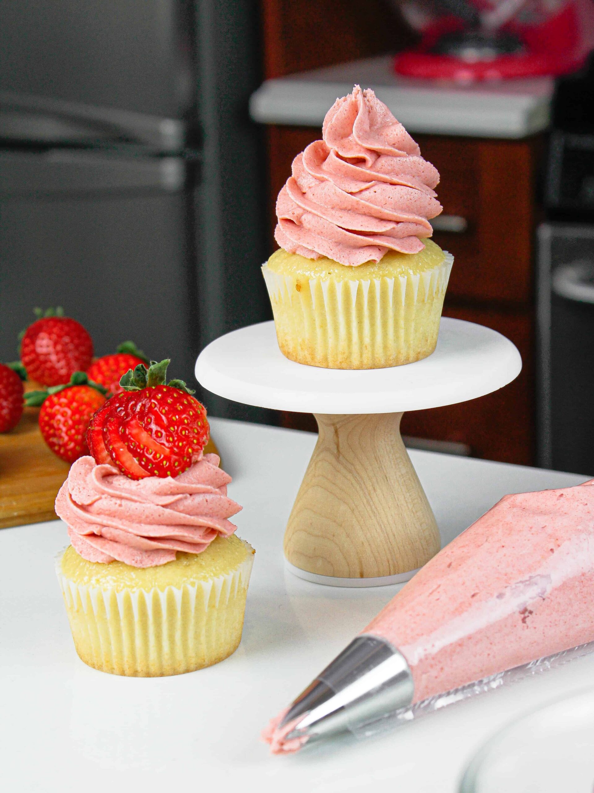 image of cupcakes with strawberry frosting piped on top