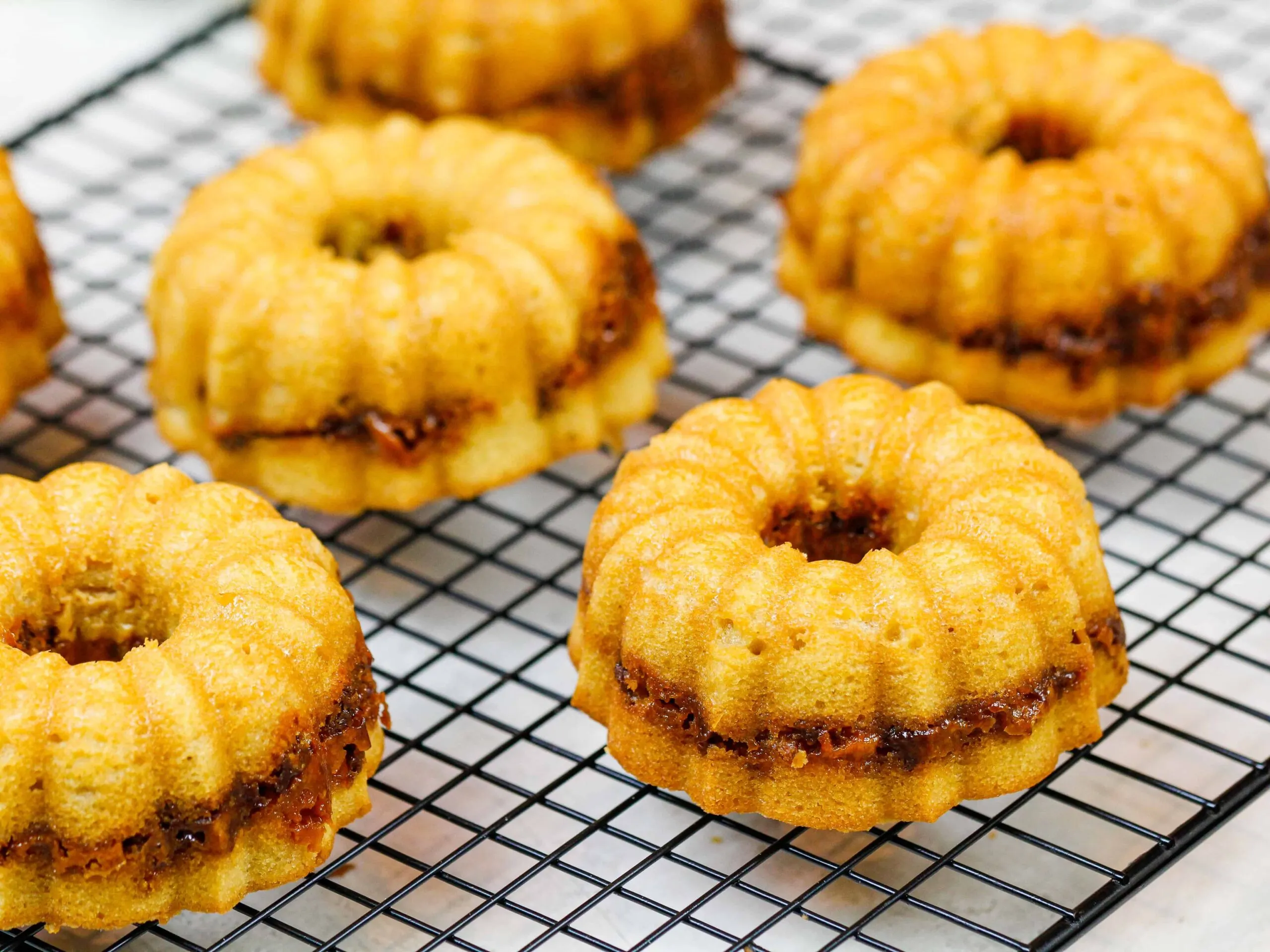 image of peanut butter mini bundt cakes baked with a butterfinger ripple through the middle