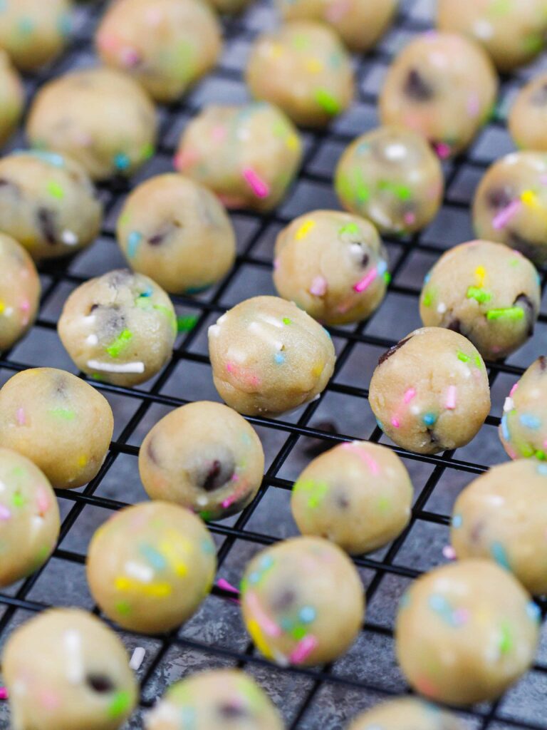 image of vegan edible cookie dough rolled out into small bites sized balls