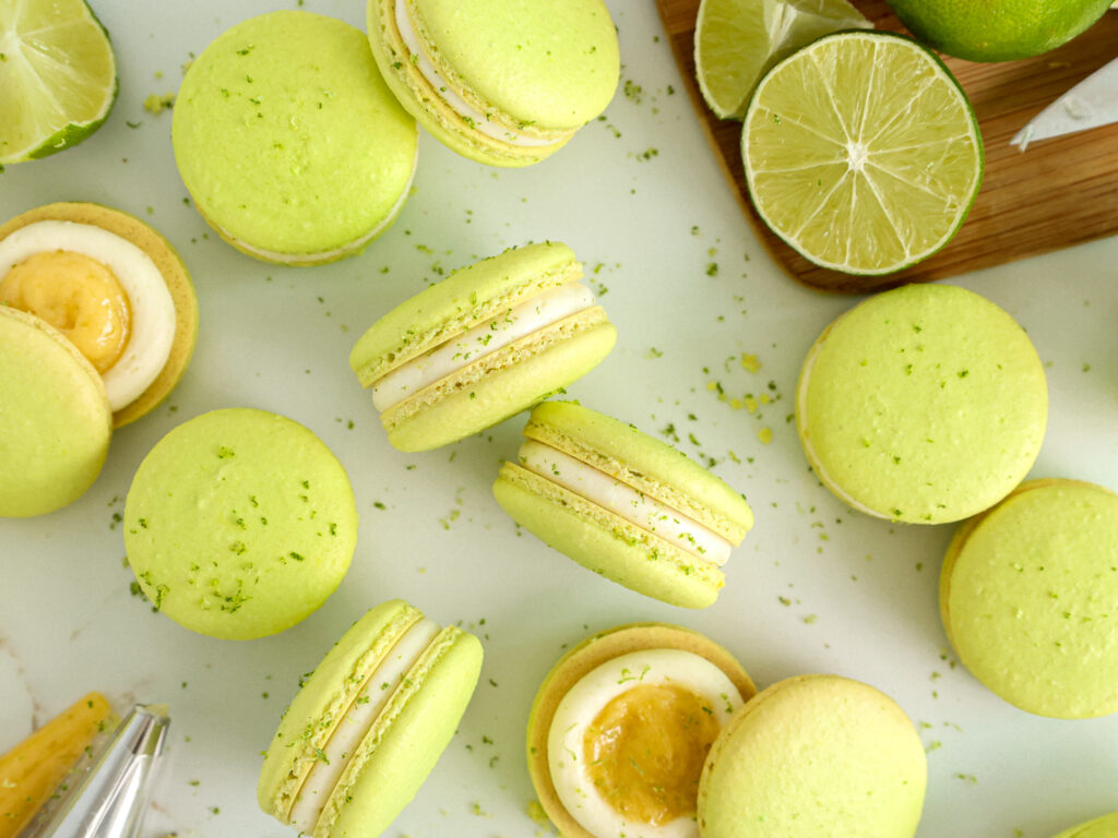 image of lime macarons stacked and are filled with lime curd and lime buttercream
