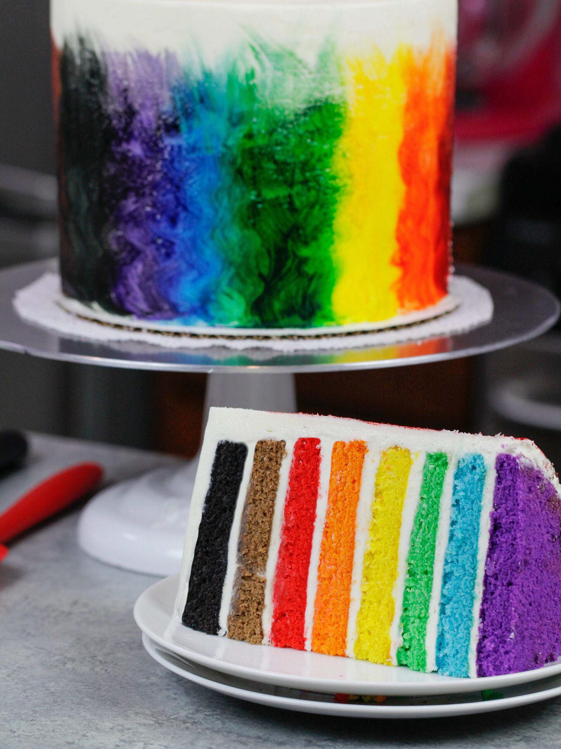 image of rainbow pride cake cut open to show 8 rainbow layers
