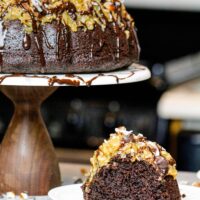 image of german chocolate pound cake with a slice on a plate to show how moist and delicious it is