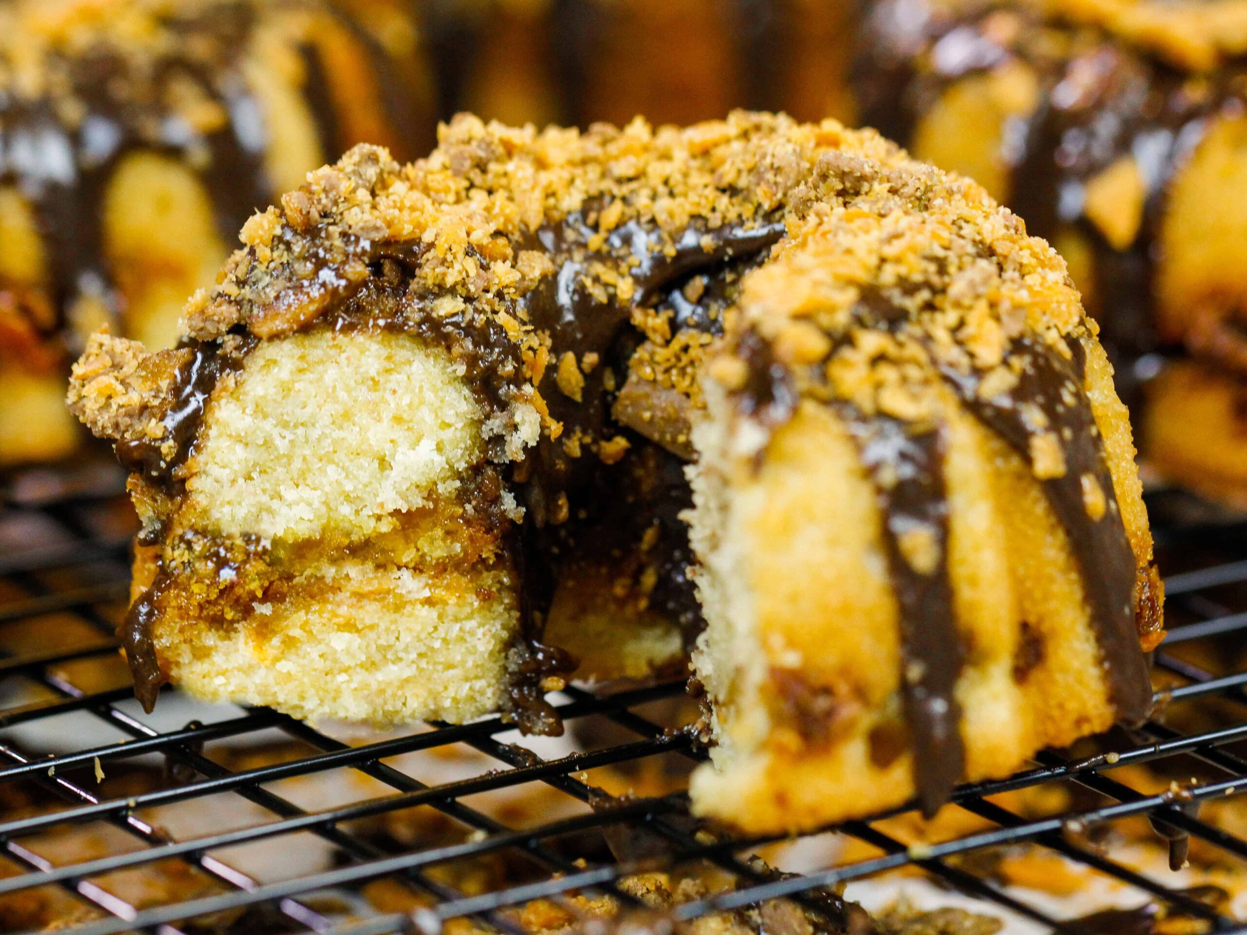 image of a mini butterfinger bundt cake that's been cut into to show it's peanut butterfinger ripple