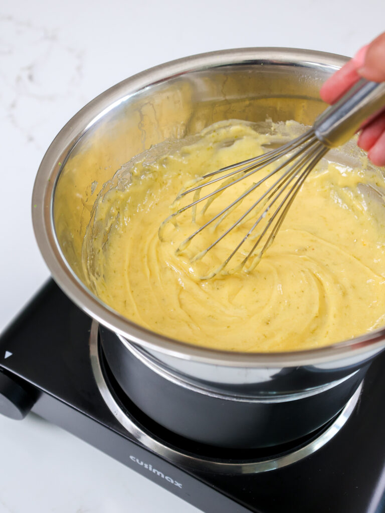 image of lime curd being cooked in a double boiler and whisked
