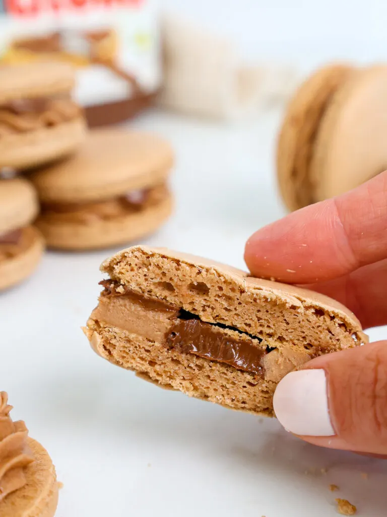 image of a Nutella macaron that's been cut in half to show its delicious Nutella filling