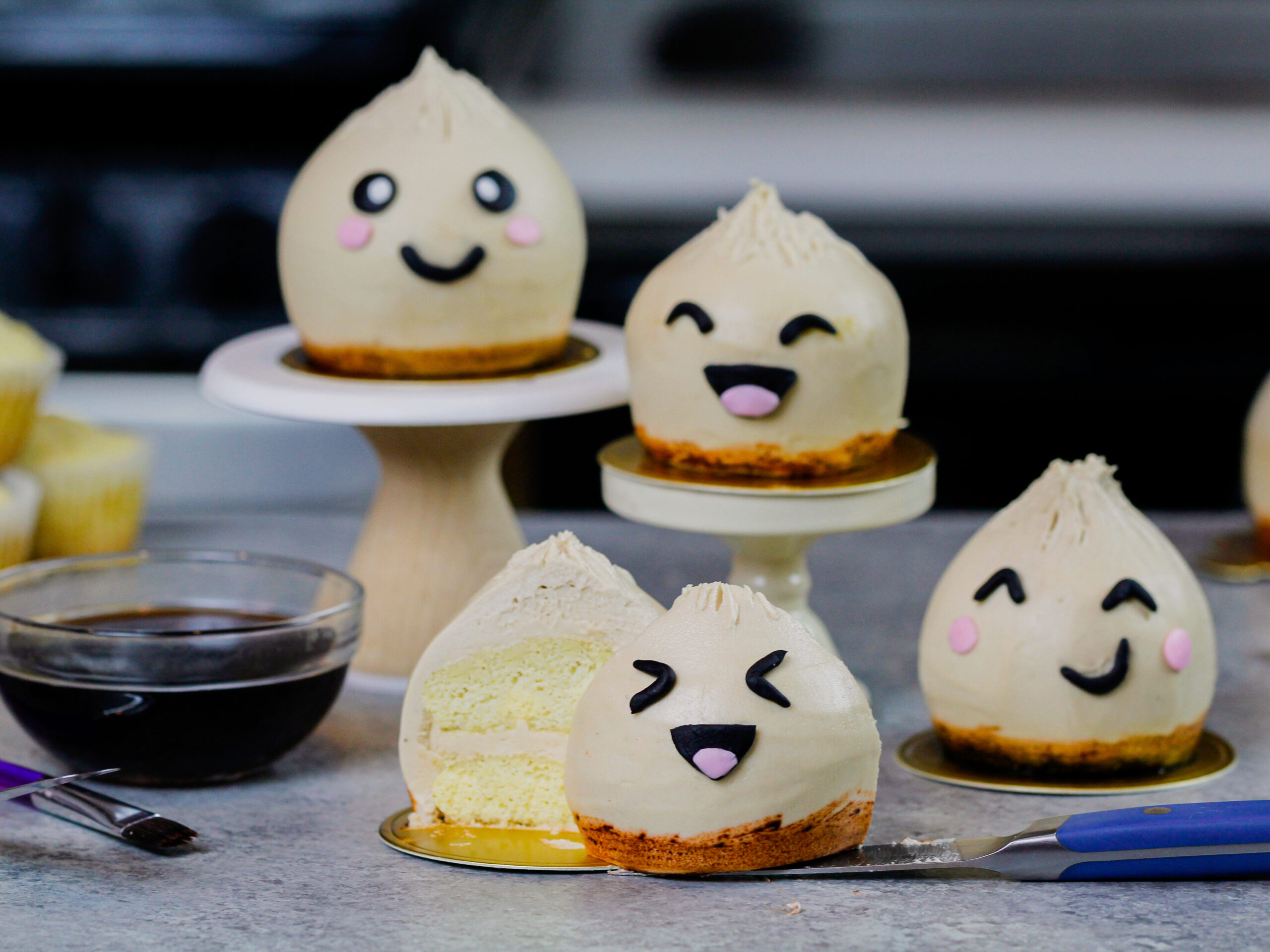 image of dumpling cupcakes with one cut open to show the moist vanilla cupcake it's made with