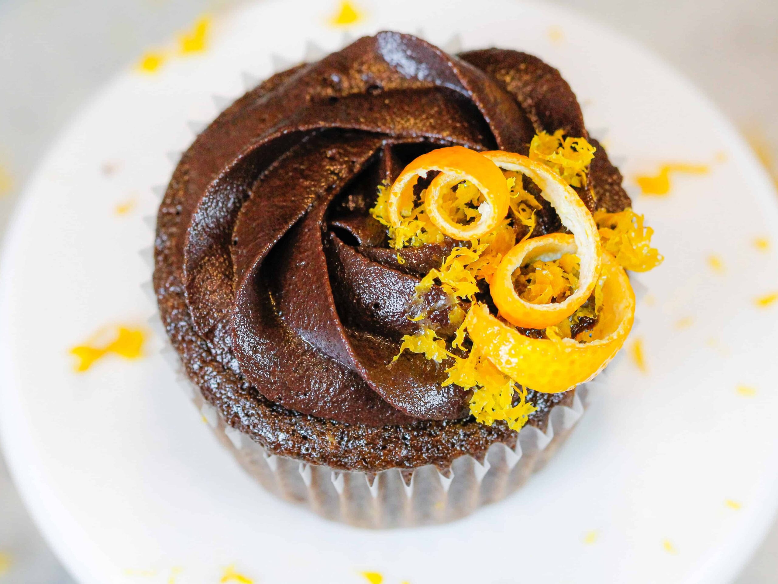 image of a chocolate orange cupcake decorated with a sprinkle of fresh orange zest