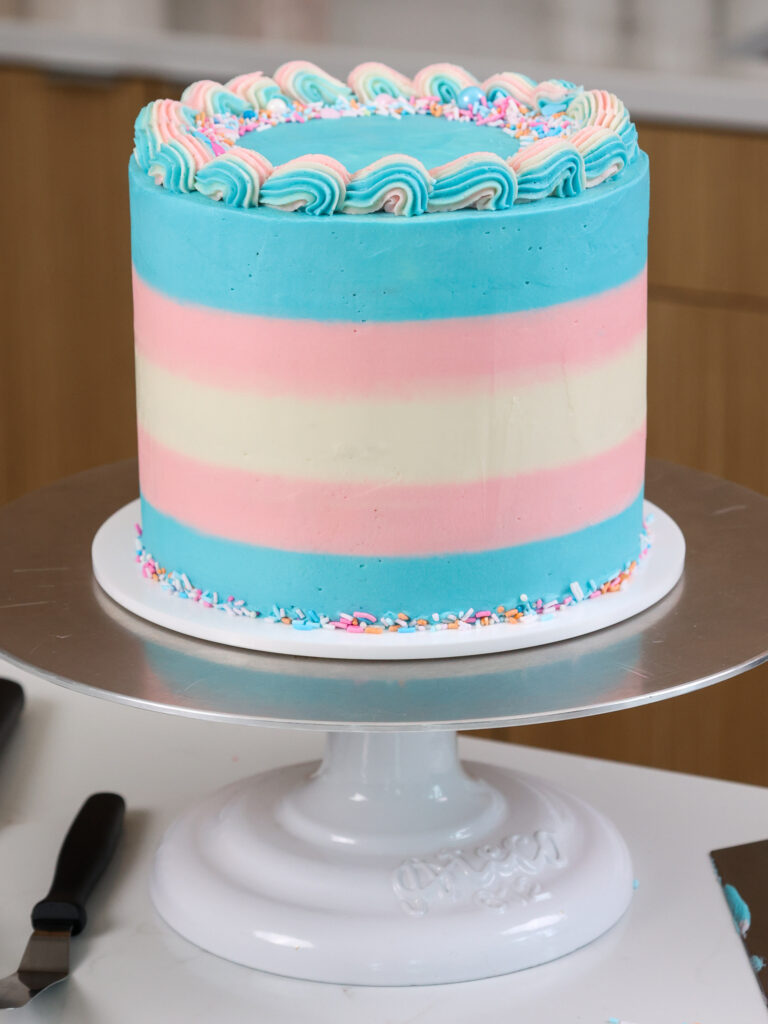 image of a trans flag cake that's been decorated with buttercream