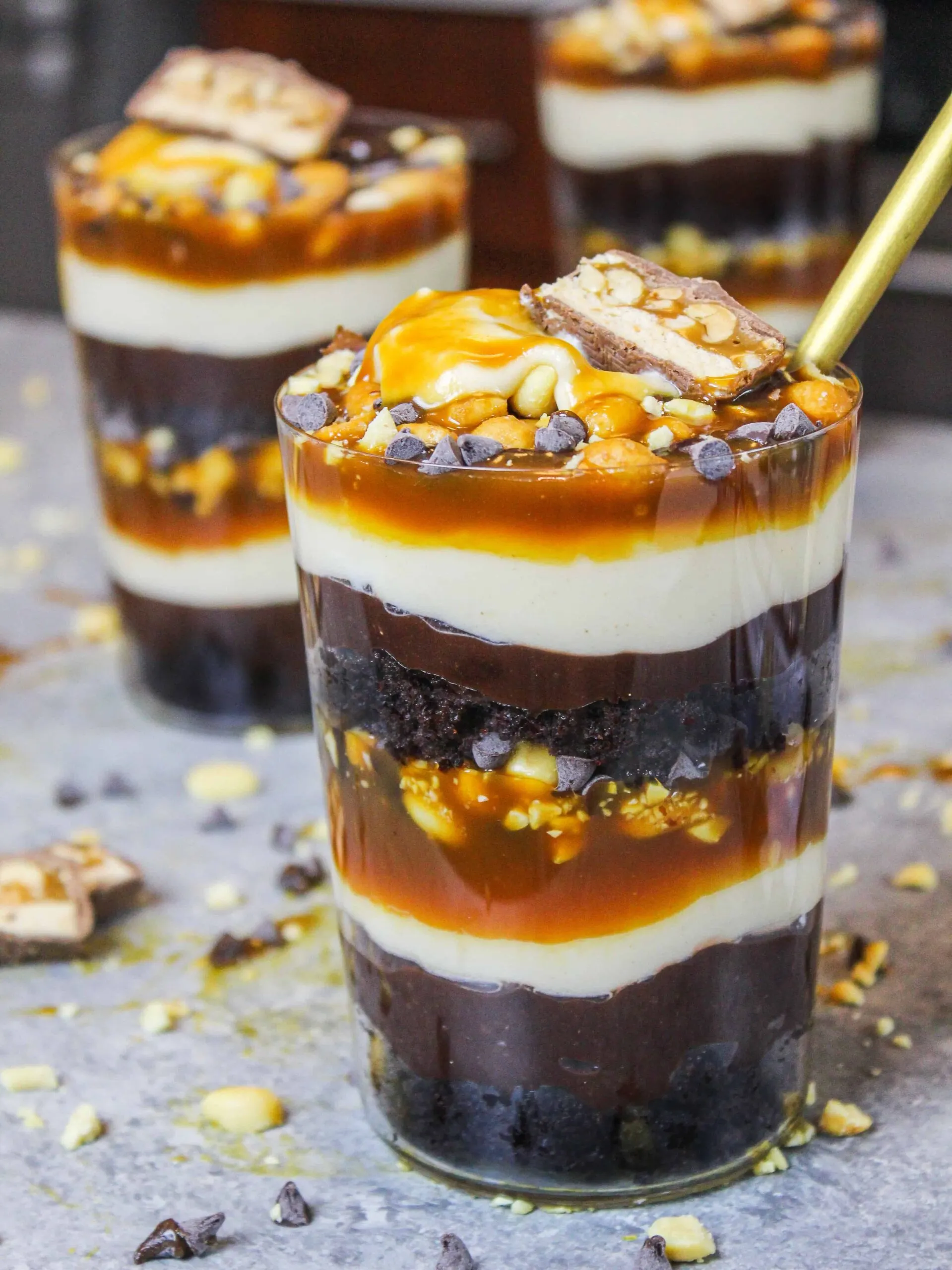 image of chocolate snickers trifle made in individual glasses to make them easy to serve and eat