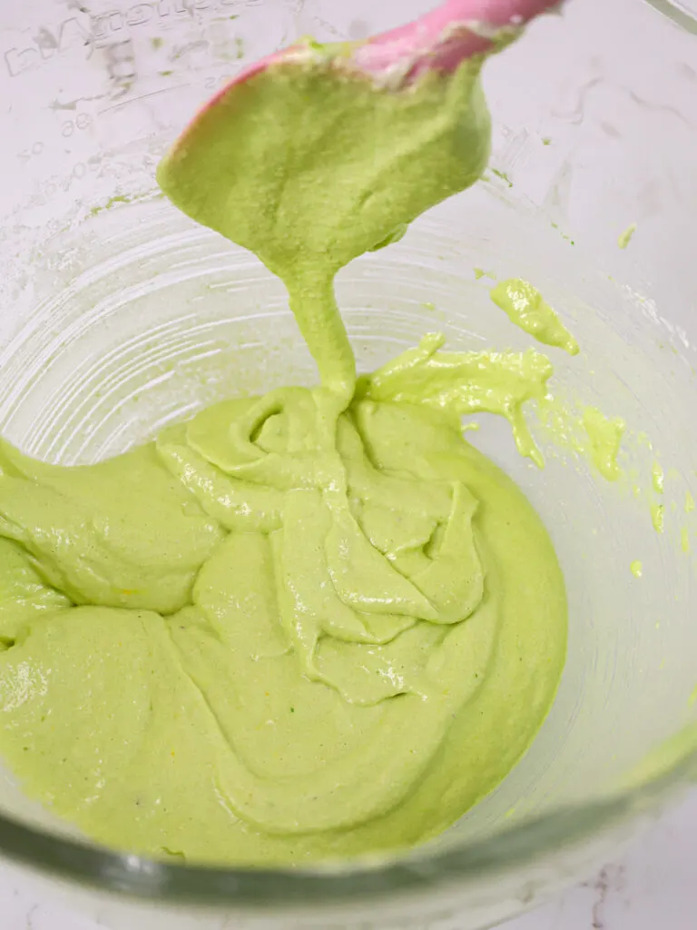 image of green macaron batter that's been mixed properly and passes the figure 8 test
