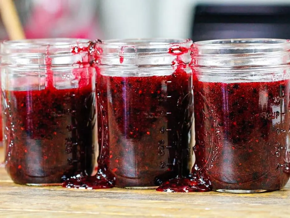 image of blackberry jam that's been poured into mason jars to set
