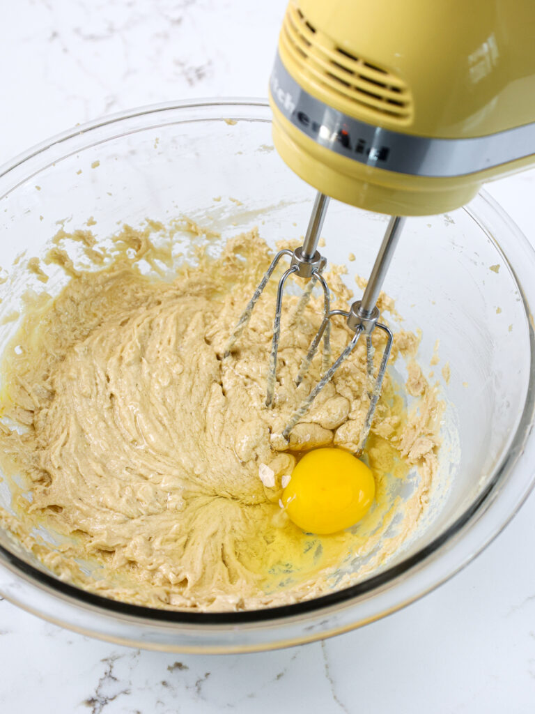 image of eggs being mixed into spice cupcake batter