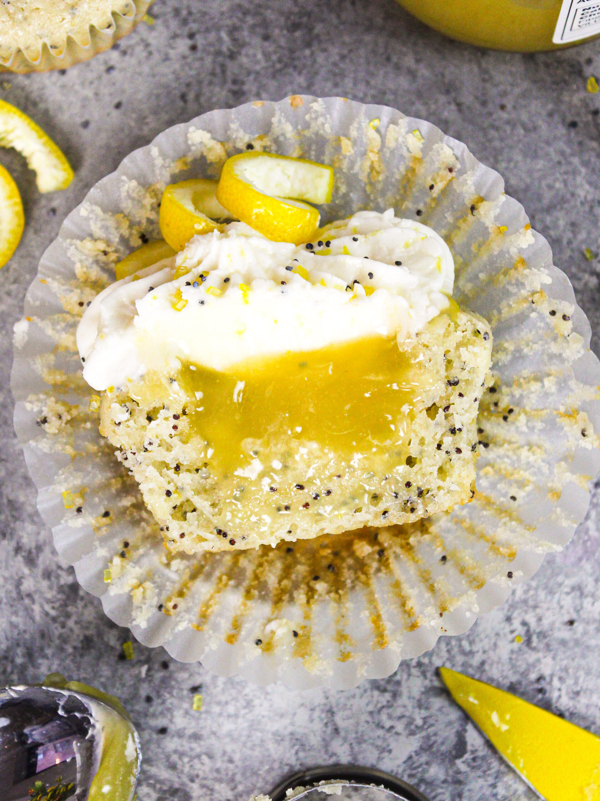 image of lemon poppy seed  cupcake cut in half to show lemon curd filling