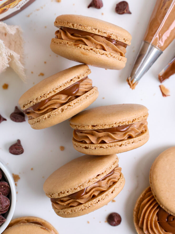 image of Nutella macarons filled with nutella buttercream and a nutella core laid out to show their filling