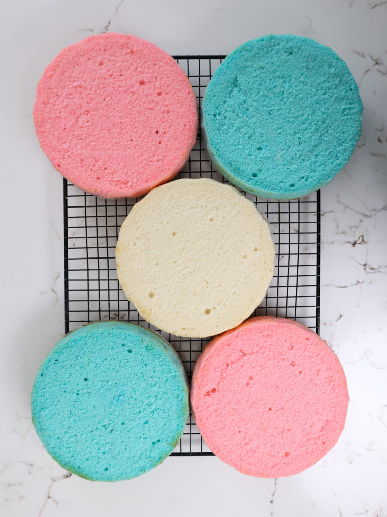 image of leveled blue, pink, and white cake layers that are ready to be used to make a trans flag cake
