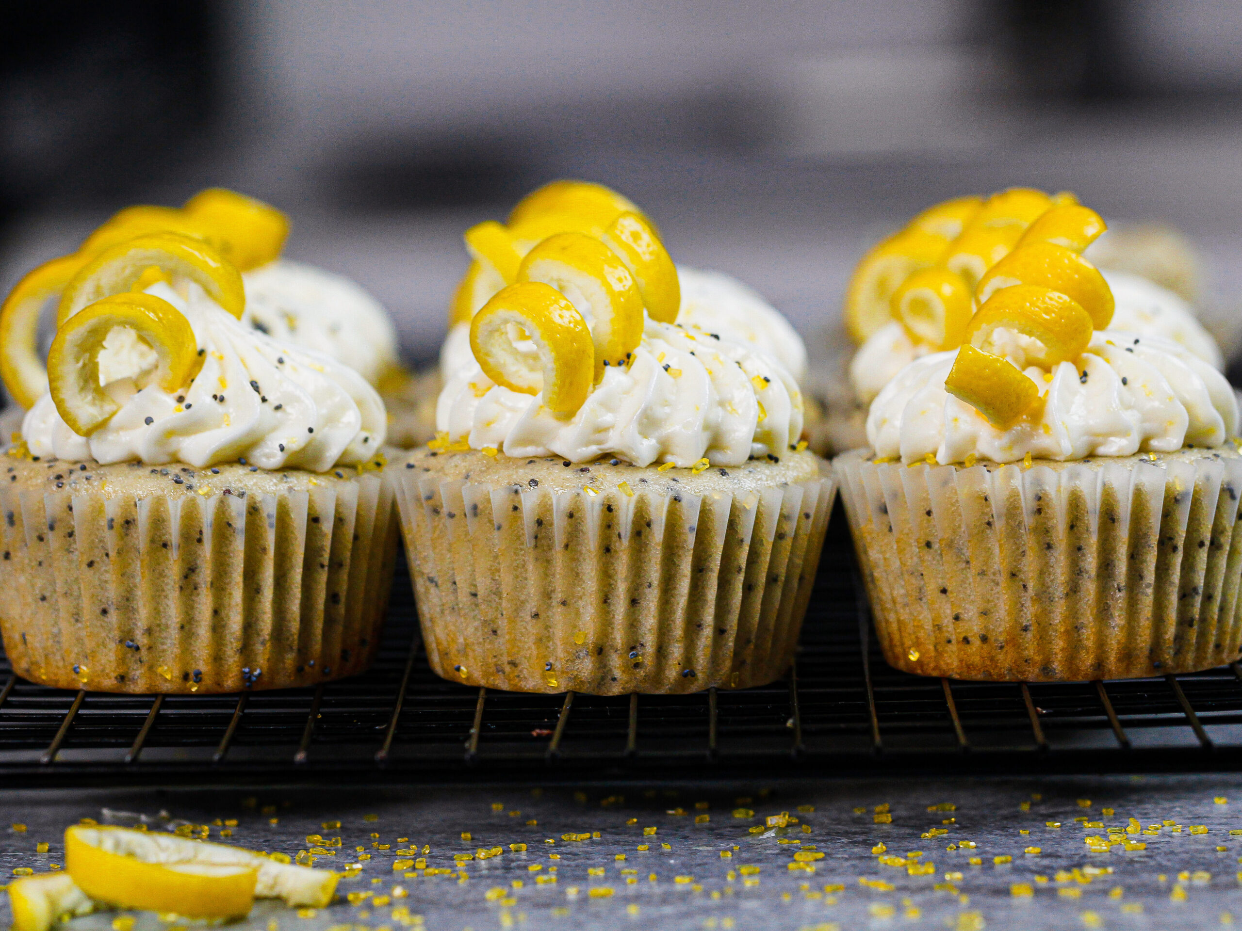 image of lemon poppy seed cupcakes decorated with lemon spirals
