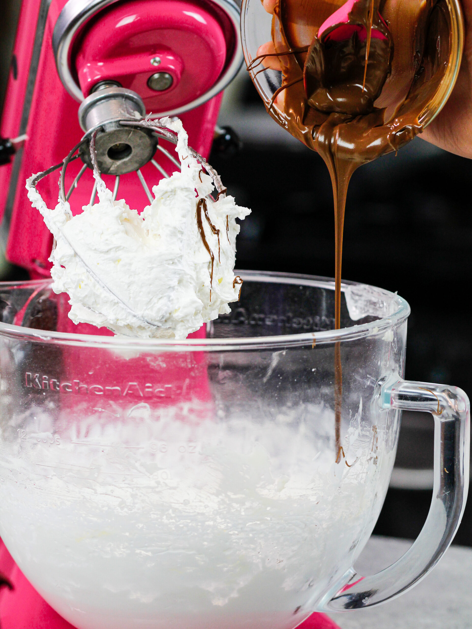 image of chocolate being poured into a stand mixer to make chocolate Italian meringue buttercream