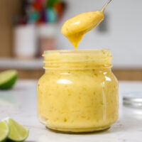 image of homemade lime curd being scooped out of a glass jar