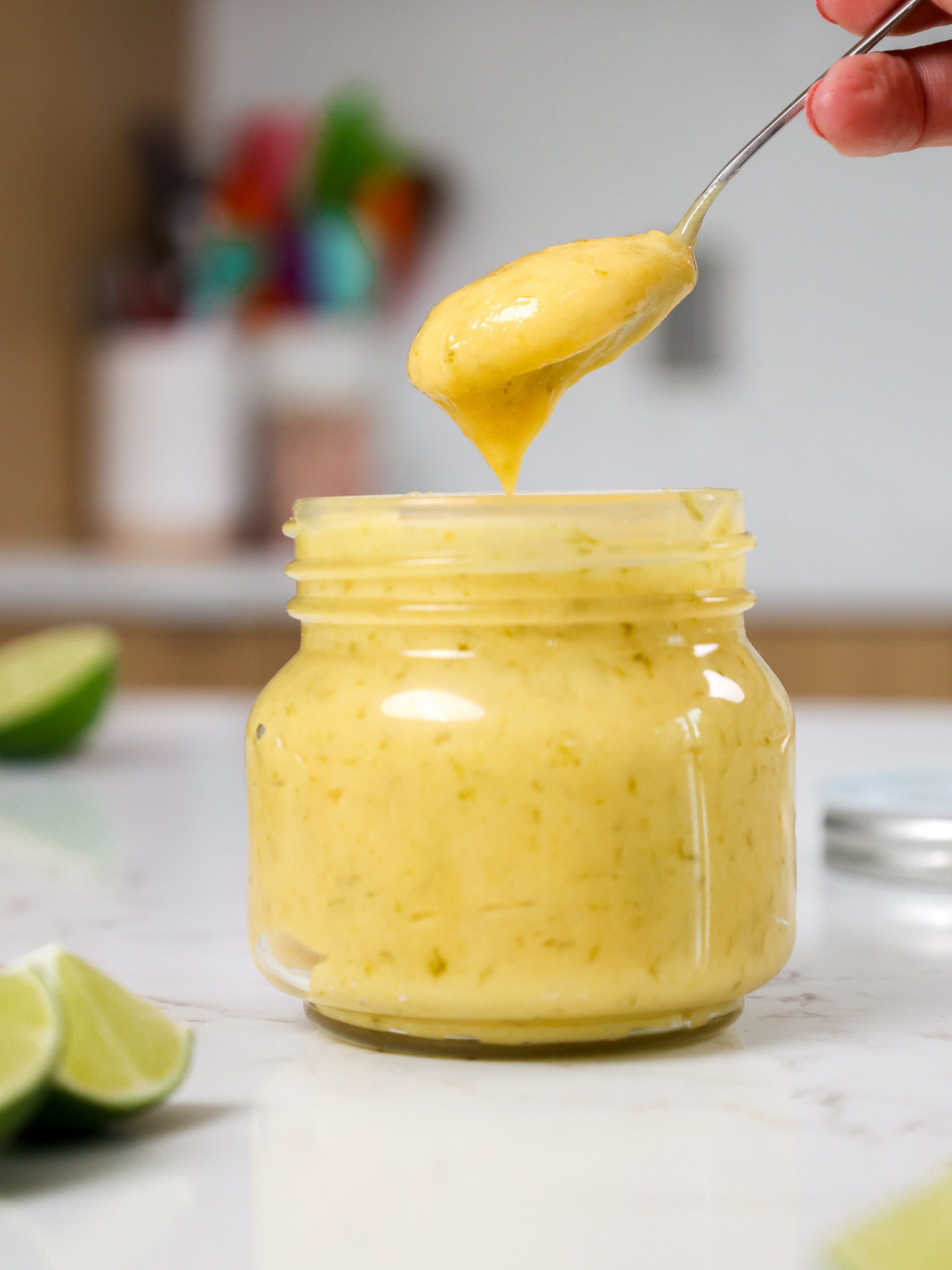 https://chelsweets.com/wp-content/uploads/2022/06/scooping-lime-curd-out-of-container.jpg