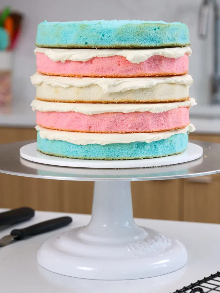 image of blue, pink, and white cake layers that have been stacked to look just like the trans flag