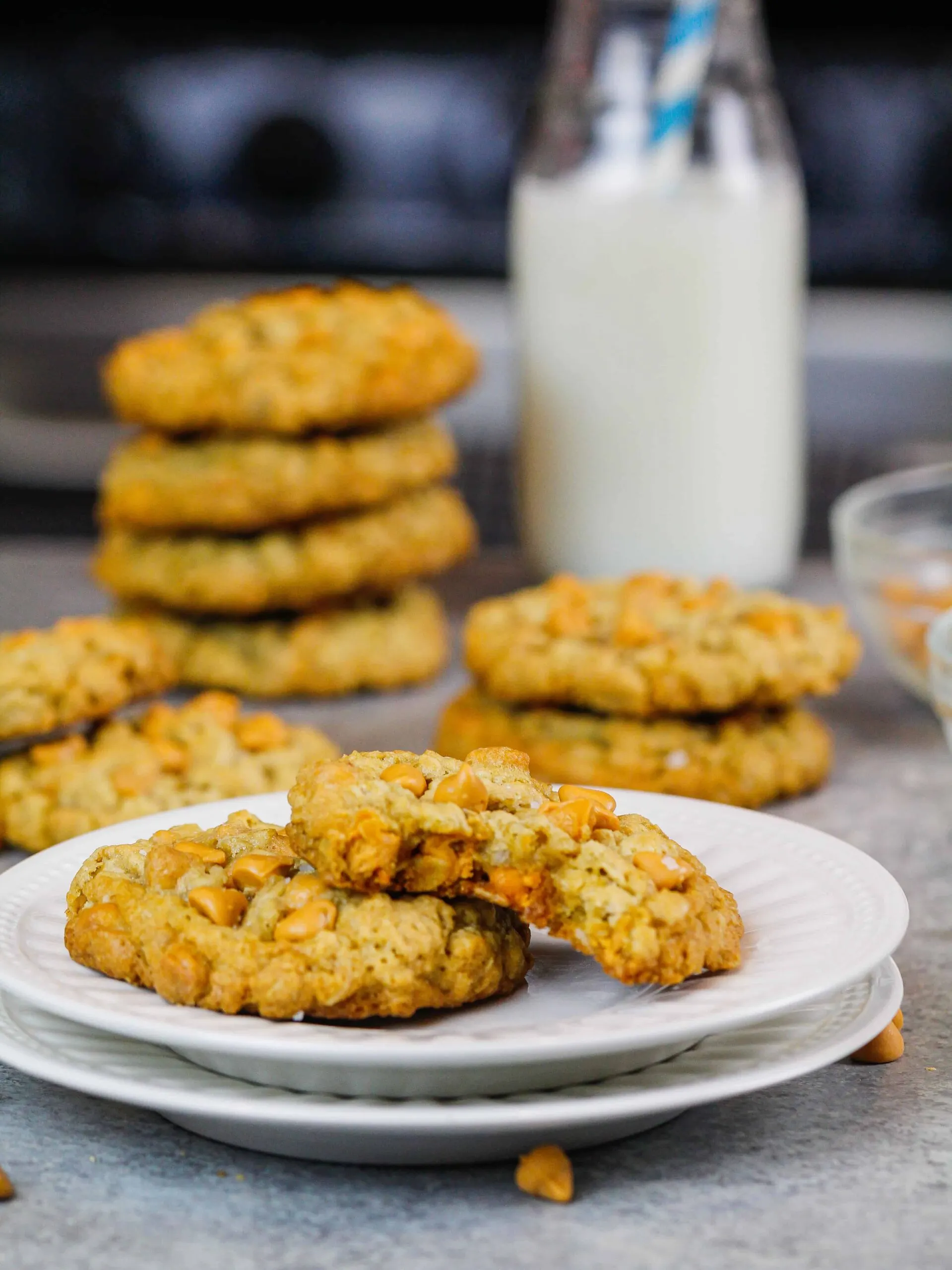 image of oatmeal scotchies on a plate with one cookie bitten into to show how soft and chewy the cookies are