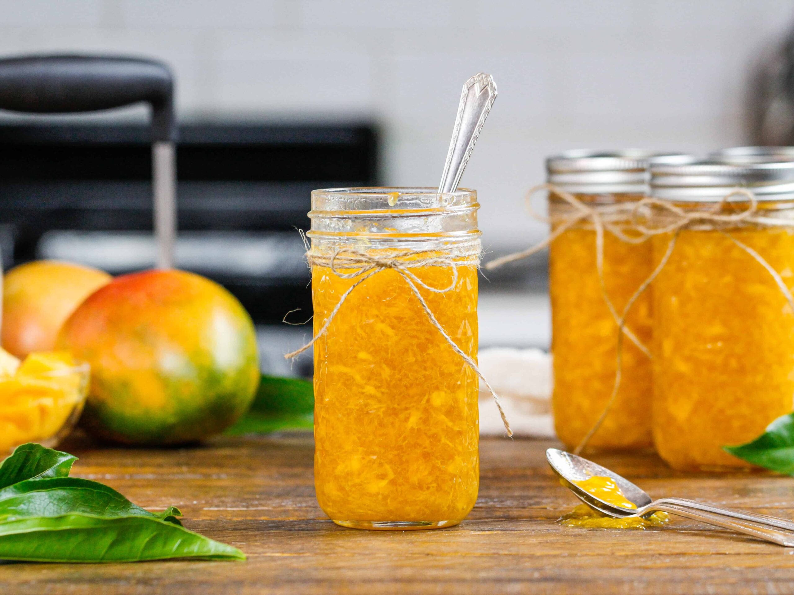 image of mango freezer jam made in a pretty mason jar