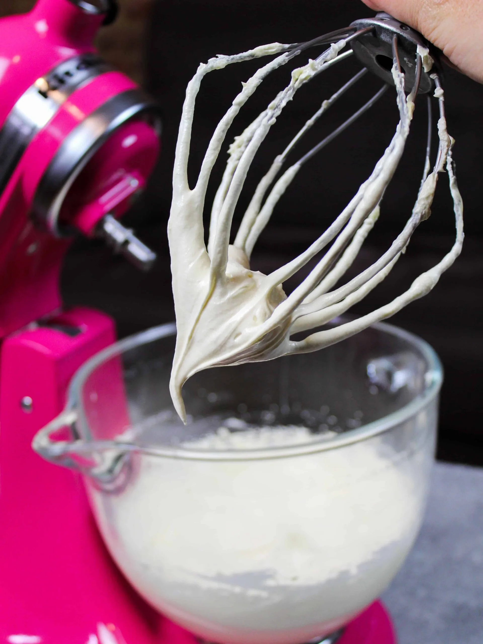image of buttercream frosting on kitchen aid whisk after being made
