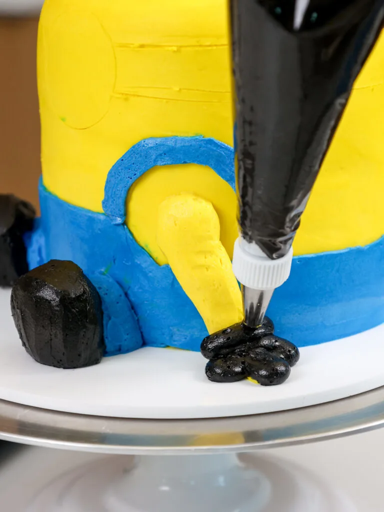 image of a glove being piped on a minion buttercream cream