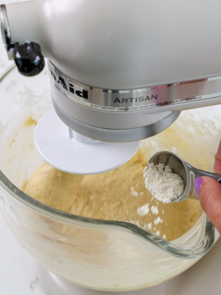 image of additional flour being added to cinnamon roll dough to make it the right consistency