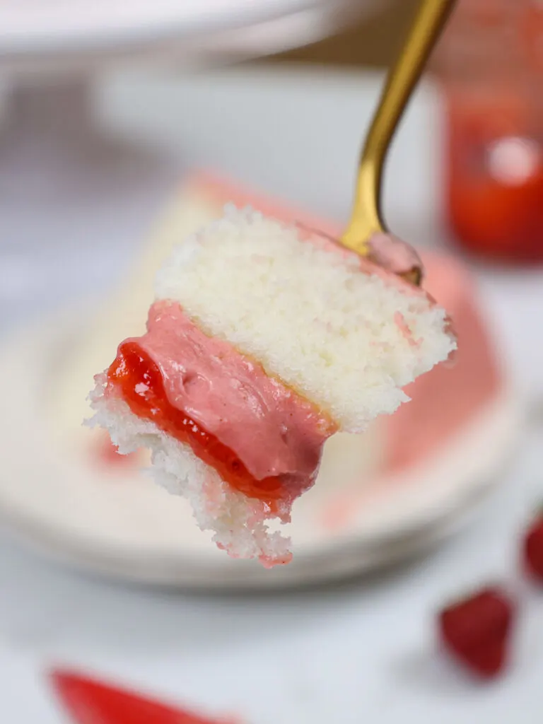 image of a bite of cake that's been filled with strawberry mousse cake filling