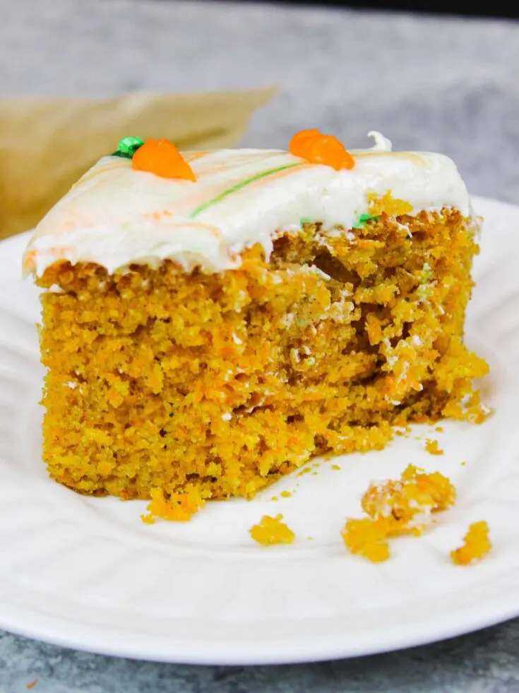 image of a slice of moist carrot cake sheet cake on a plate.