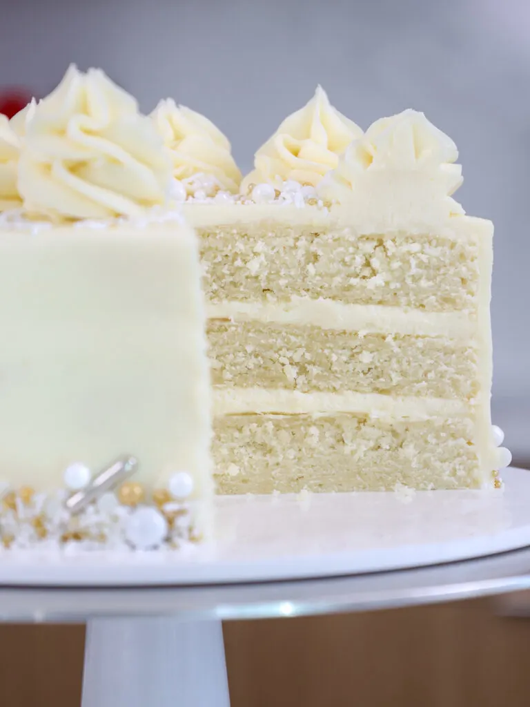 image of a WASC cake that's been cut into to show its cross section of moist, tender, white almond sour cream cake layers