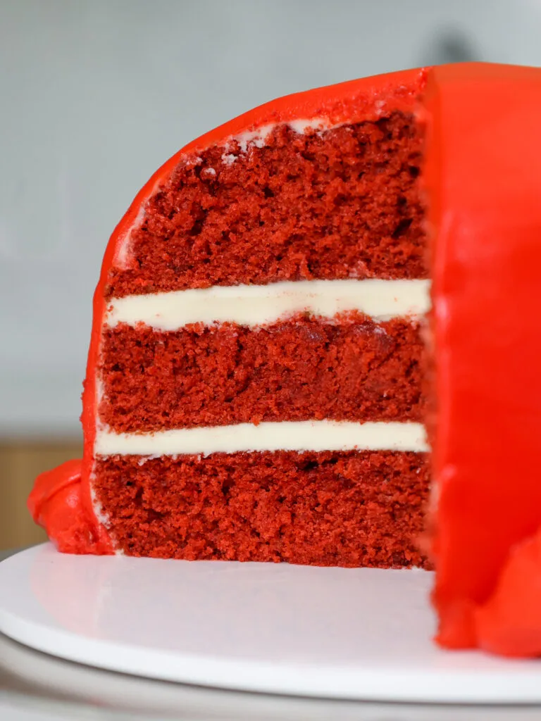 image of a red velvet layer cake that's been frosted with buttercream frosting