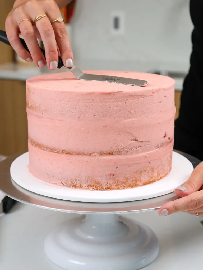 image of a strawberry cake being crumb coated