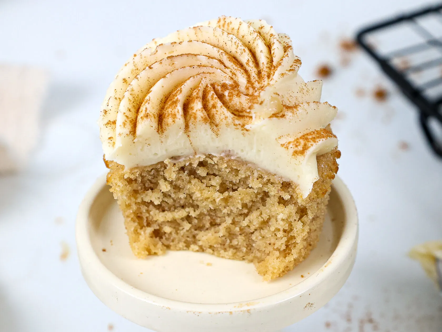 image of a spice cake that's been bitten into to show how moist and tender the cupcake is