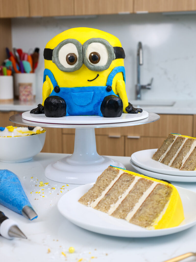image of an adorable buttercream minions cake made with banana cake layers and vanilla buttercream frosting