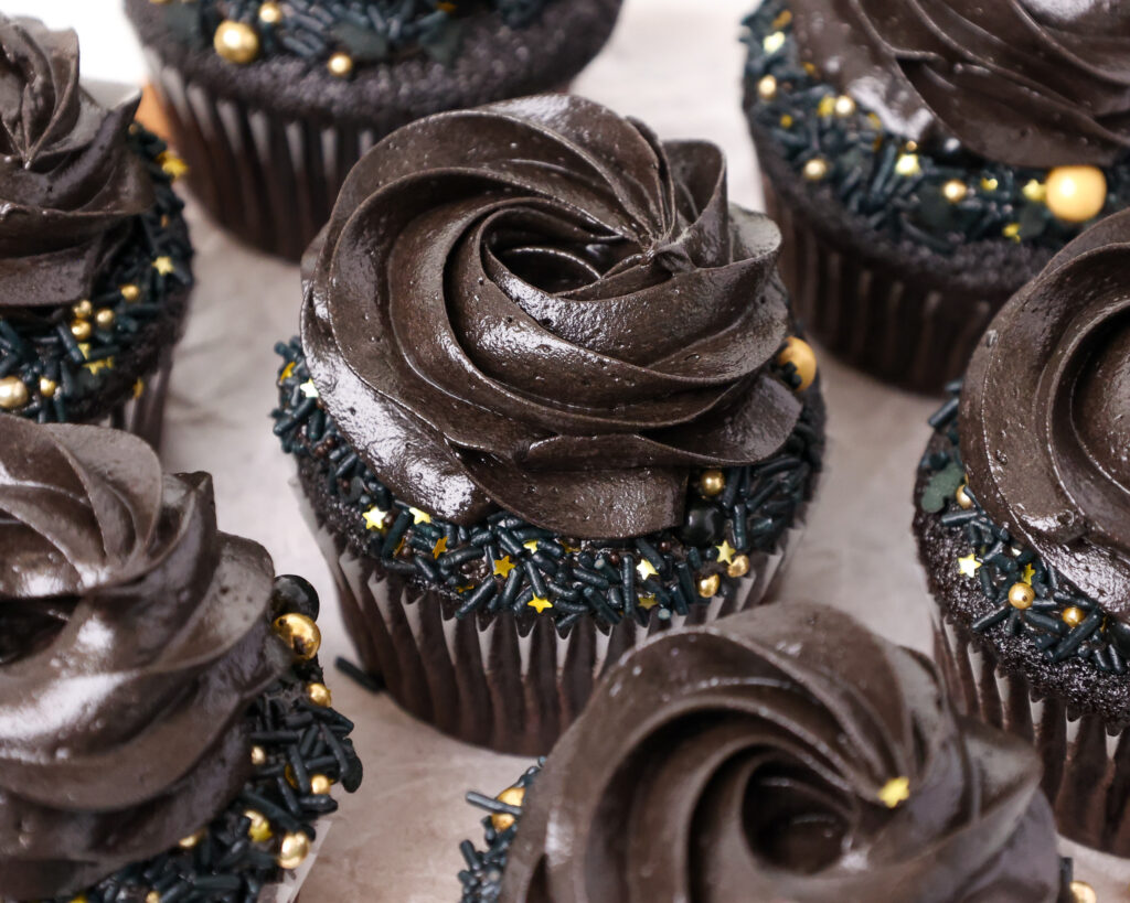 image of a black velvet cupcake that' been frosted with black cocoa buttercream