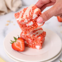 image strawberry rice krispie treat squares being placed on a plate