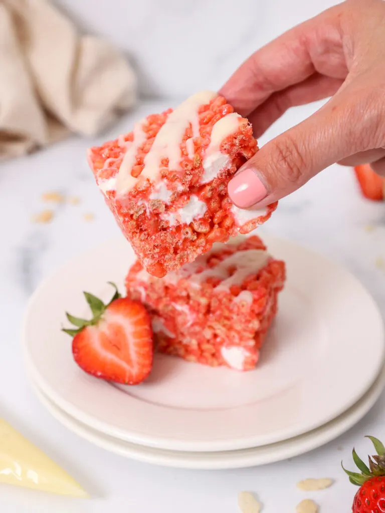 image strawberry rice krispie treat squares being placed on a plate