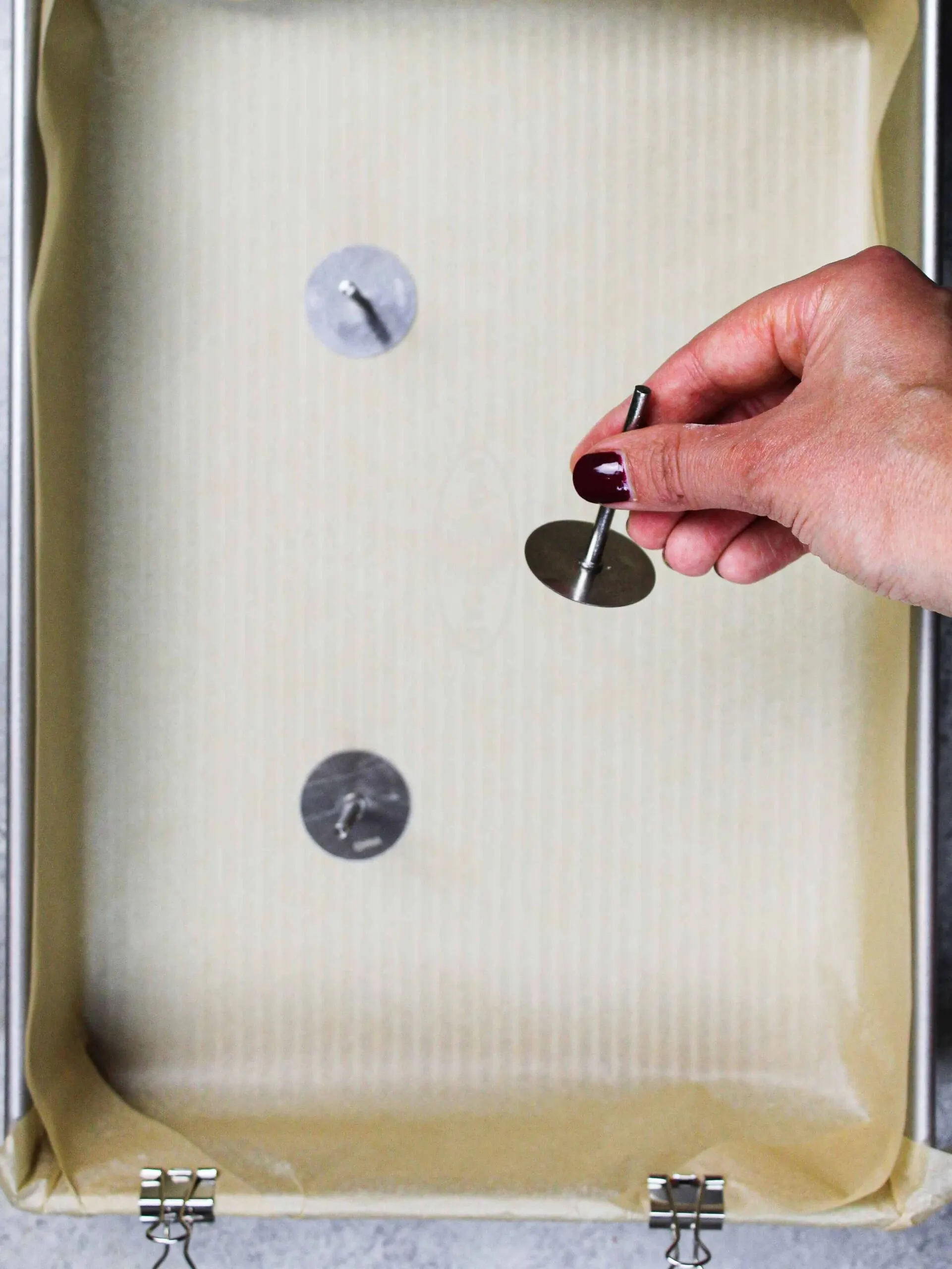 image of sheet cake pan with flower nails being used as heating cores to help the cake bake more quickly and evenly
